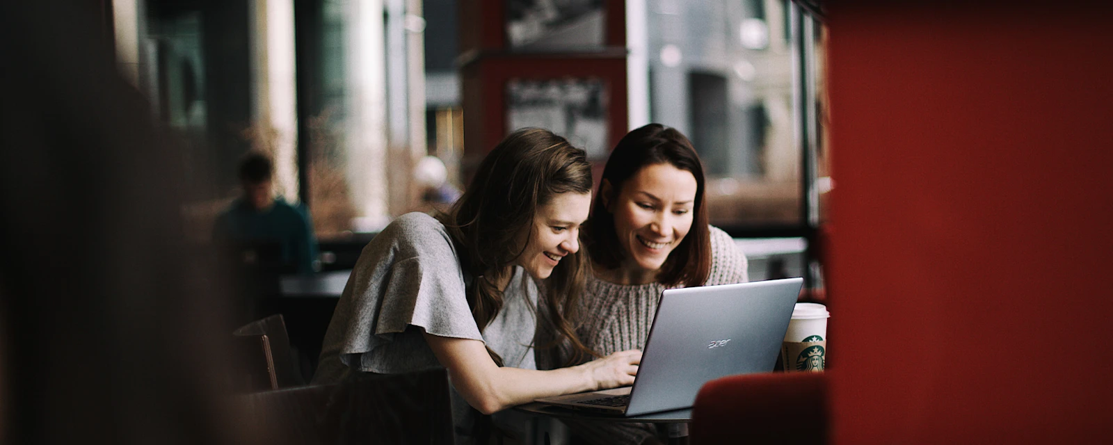 Two women looking at a laptop together